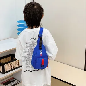 Blue nylon kids crossbody bag with letter print and adjustable strap in lifestyle shot