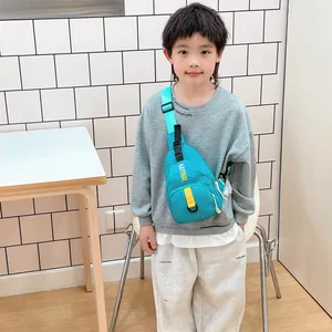 Kids casual crossbody chest bag in bright teal nylon with yellow letter decoration