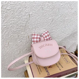 Detail view of pink mini crossbody bag with a plaid bow and cute cat embroidery
