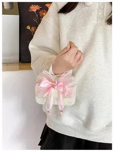 Close-up of lace girl's bag with a pink tulle bow and sparkling star sequins