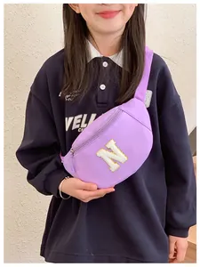 Close-up of purple nylon fanny pack featuring a sequined plush letter N on a child model