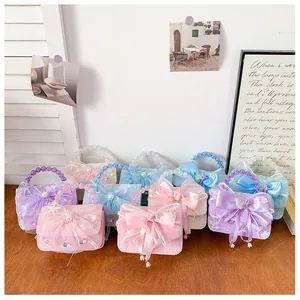 Detail of colorful lace princess handbags with satin bows and pearl bead handles