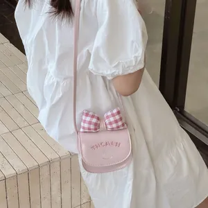 Mini pink crossbody bag for kids with bow decoration and stylish shoulder strap