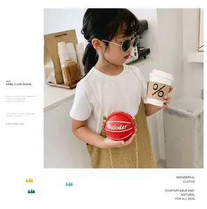 Close-up of children's mini red basketball crossbody bag with gold chain and PU leather