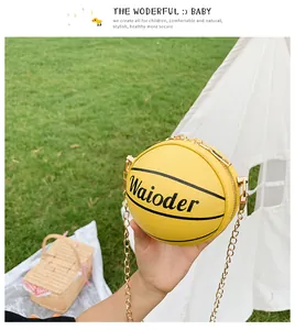 Detail of yellow basketball shaped kids bag featuring textured PU leather and metal chain strap