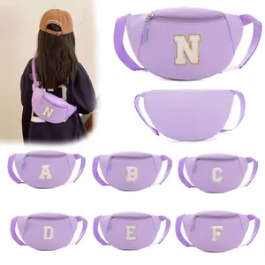Detailed view of children's purple waist bag with chenille letter patches and adjustable strap