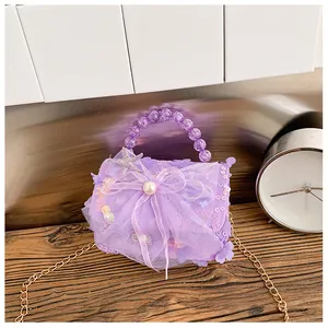 Détail du sac à paillettes violettes pour filles avec nœud, poignée en perles et chaîne
