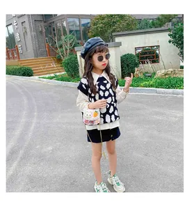 Fashionable young girl wearing a pink pearl chain bag with cute rabbit and carrot details