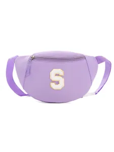 Close-up of purple nylon waist bag featuring a textured letter S patch and gold embroidery