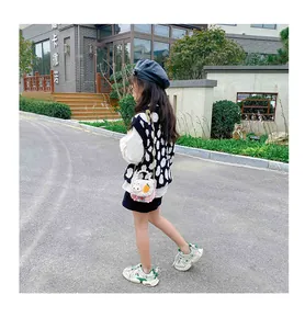 Toddler girl outfit featuring a pink plush rabbit crossbody bag and polka dot vest
