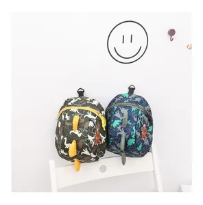 Detail of camouflage dinosaur backpacks with 3D fins and matching cute rubber charms
