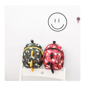 Detail of cartoon dinosaur kids backpack with 3D fins and waterproof camo fabric texture