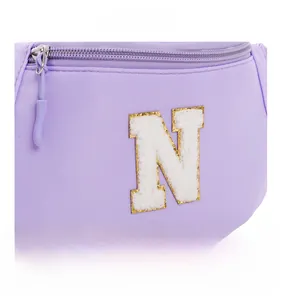 Detail of light purple nylon kids chest bag with chenille letter N and golden sequins