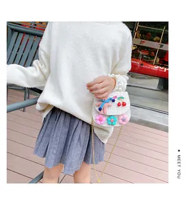 Detail of tweed crossbody bag with pearls, pink bunny, and colorful floral accents