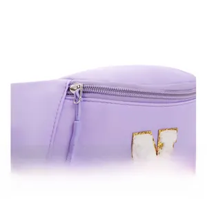 Detail of purple fabric waist bag with smooth metal zipper and chenille letter N patch