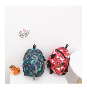 Detailed view of the 3D dinosaur spines and cute cartoon charms on kids backpacks