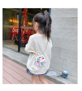 Detail of tweed girl's crossbody bag with pearl handle, rabbit and floral ornaments