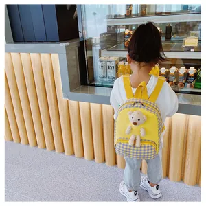 Detailed back view of kids yellow and purple checkered backpack with plush bear