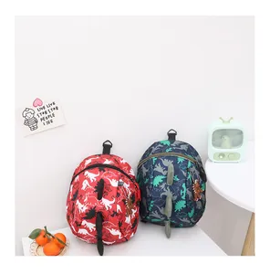 Detail of cartoon dinosaur backpacks with 3D fins and water-resistant nylon fabric