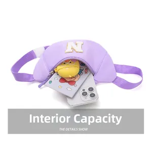 Detail showing internal capacity of purple nylon waist bag with embroidered N letter
