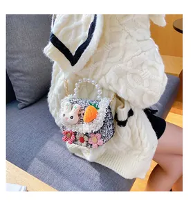 Detail of tweed kids crossbody bag with pearl handle, rabbit decor and floral embroidery