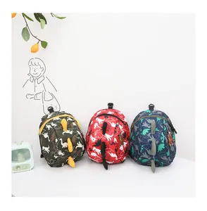 Detailed view of kids dinosaur backpacks in green, red, and navy with 3D spine scales