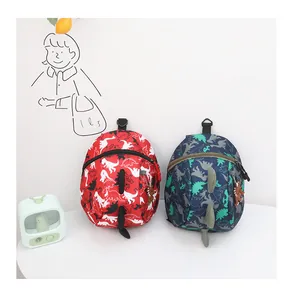 Detail view of red and navy dinosaur backpacks with 3D spikes and cartoon prints