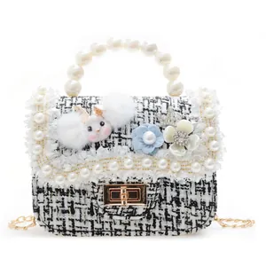 Elegant tweed girls' handbag with pearl handle and flower rabbit decor on white background