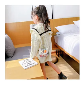 Detail of girls woven crossbody bag with pearl handle and cute 3D bunny floral decorations
