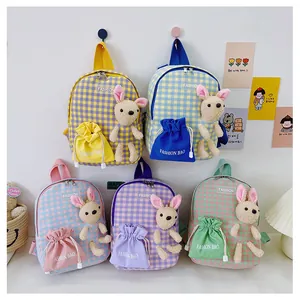 Group display of five colorful cartoon rabbit backpacks for kids in plaid canvas