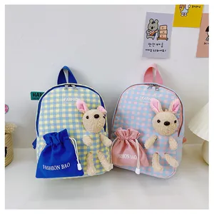 Detail of cute rabbit backpack for kids featuring plush ears and checkered fabric texture