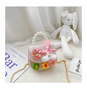 Detail of pink tweed toddler bag with pearl handle and plush bunny ornament