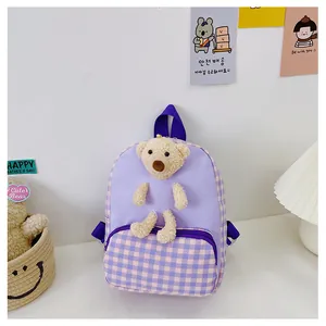Detail view of purple checkered toddler backpack with a cute 3D plush brown teddy bear