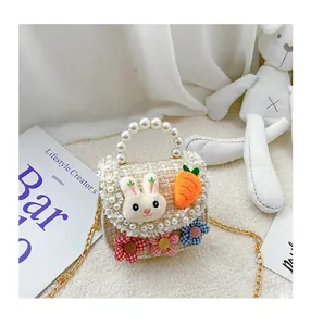 Detail of tweed kids crossbody bag with cute plush rabbit, carrot and pearl handle