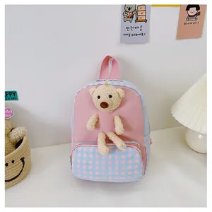 Detail of pink canvas toddler backpack with a 3D plush bear and checkered front pocket