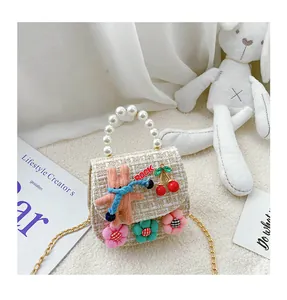 Detail of tweed kids crossbody bag with 3D bunny, pearl handle and metal chain