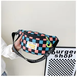 Close-up of checkered waist bag featuring ADDR label and yellow zipper detail
