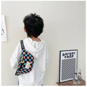 Close-up of pink and teal checkerboard kids chest bag with lettered adjustable strap