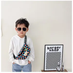 Kids checkered chest bag featuring Born Champ straps and vibrant neon yellow zipper details