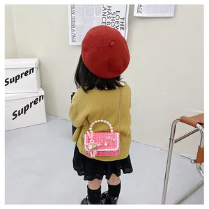 Sac bandoulière rose pour enfant avec poignée en perles et adorable lapin peluche