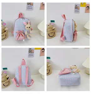 Detail view of pink and blue checkered kids backpack with plush bunny and dual zippers