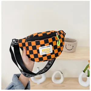 Macro detail of kids checkered chest bag with neon green zipper pull and logo patch