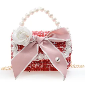 Mini tweed girls handbag with pink bow and pearl handle in red and white color