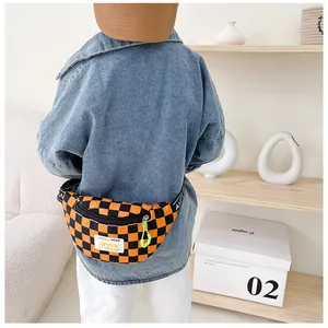 Detail of kids canvas waist bag featuring orange checkerboard pattern and adjustable strap