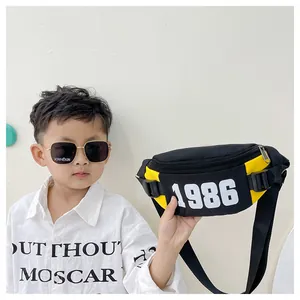 Close-up of kids sports fanny pack in black and yellow with white 1986 numeric print
