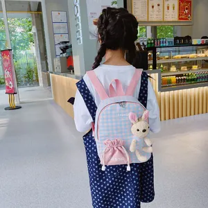 Cute bunny kids backpack with blue pink plaid and plush rabbit doll on model