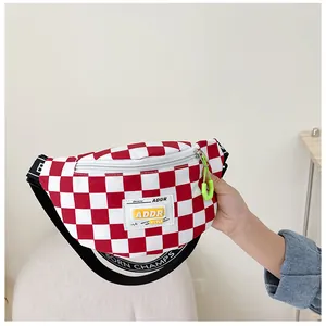 Detail of red checkerboard kids fanny pack with ADDR label and BORN CHAMPS strap