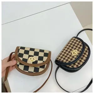 Close-up of vintage mini saddle bags in checkered and houndstooth patterns with metal locks