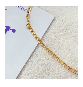 Close-up of bright golden link chain showing polished metal texture and craftsmanship
