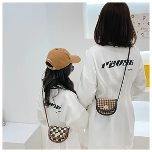 Detail of mini saddle bags showing classic checkerboard and houndstooth patterns with metal clasps
